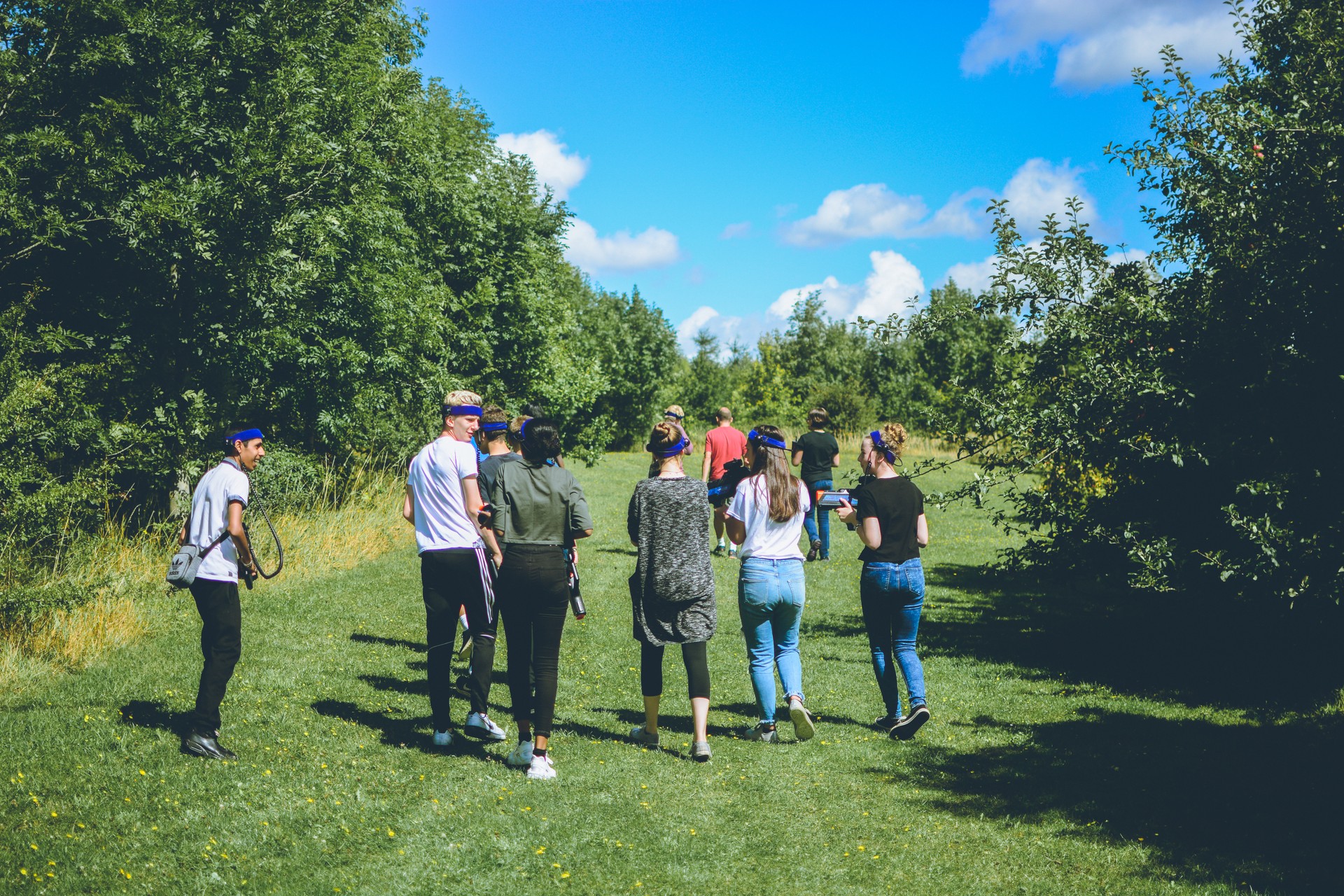 Campers playing laser tag in the woods on site.