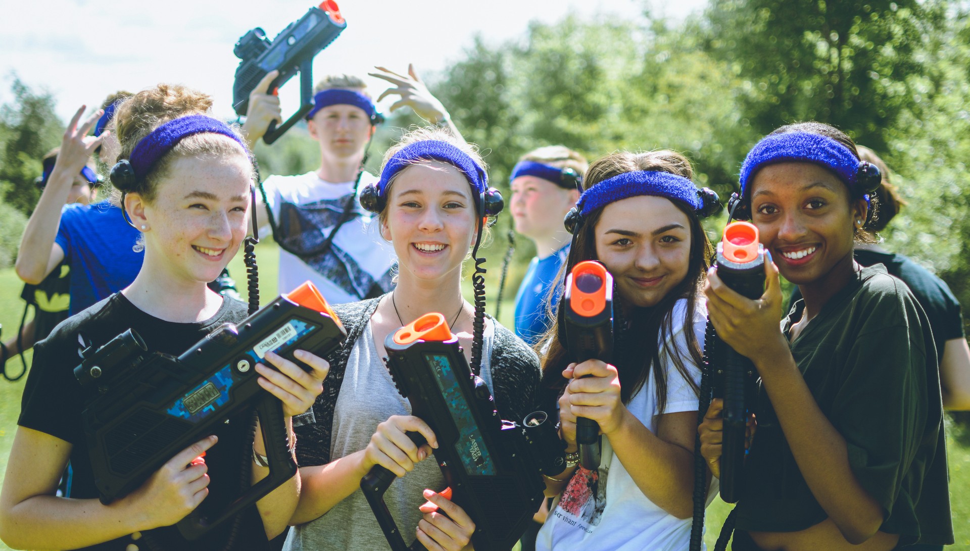Campers smiling and holding laser tag gear